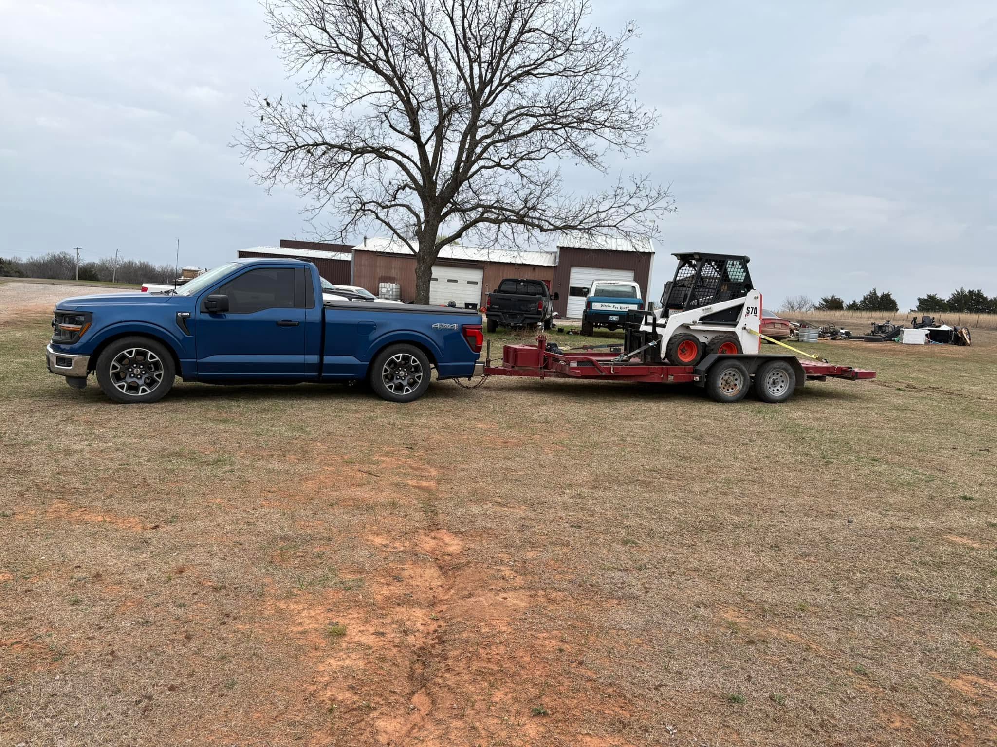 Skid steer on the trailer, headed to a job